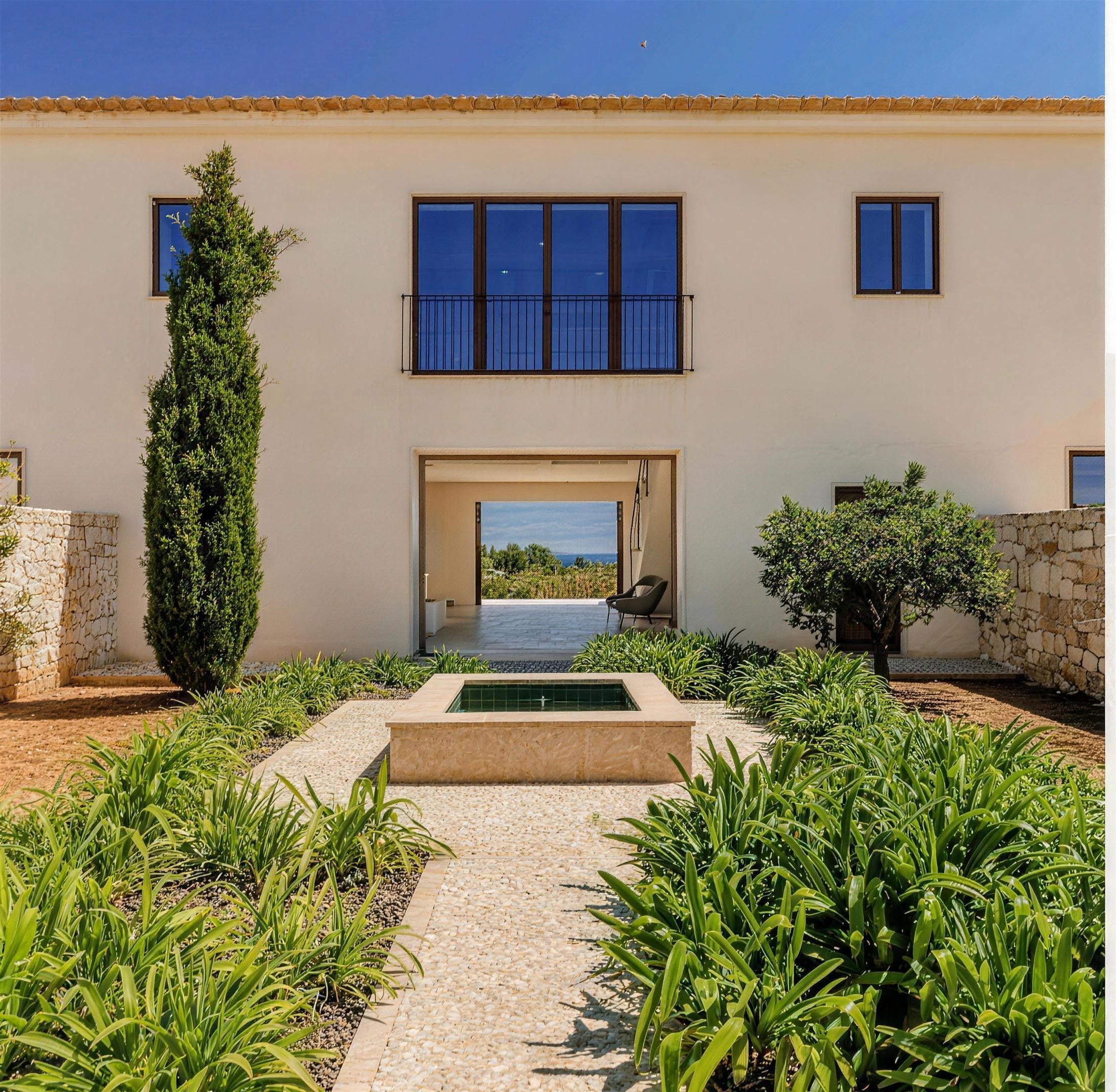Lucera 07 Lucera, Cala Llombards, Mallorca – entrance framed by natural stone walls and a fountain